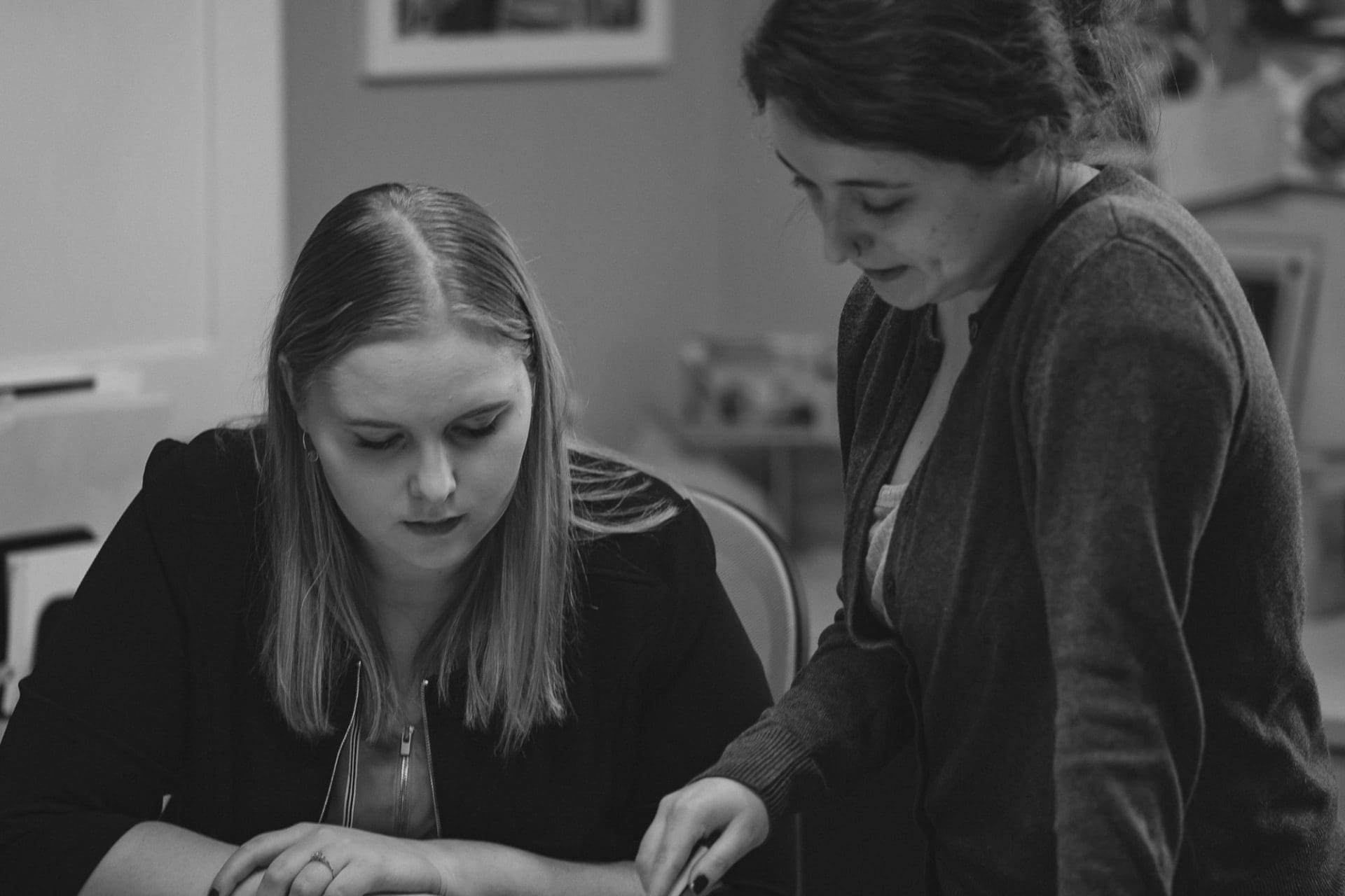 two women looking at paper